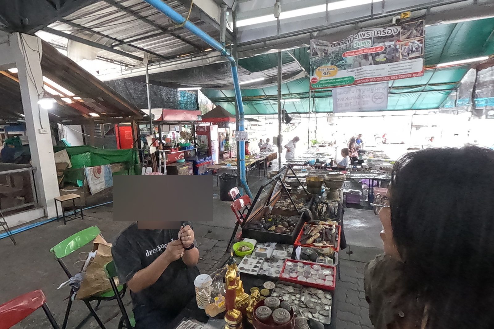 A curio dealer at his table by the open side