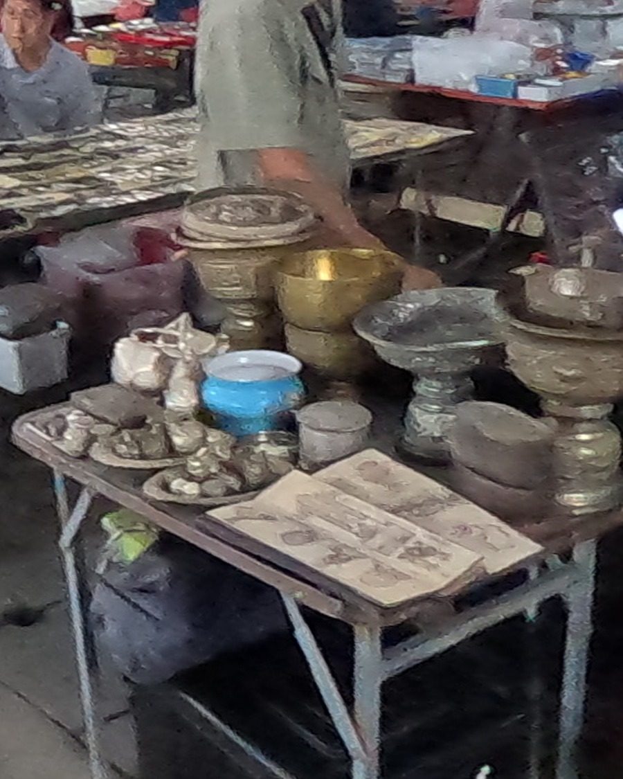 Brass footed bowls and an open book