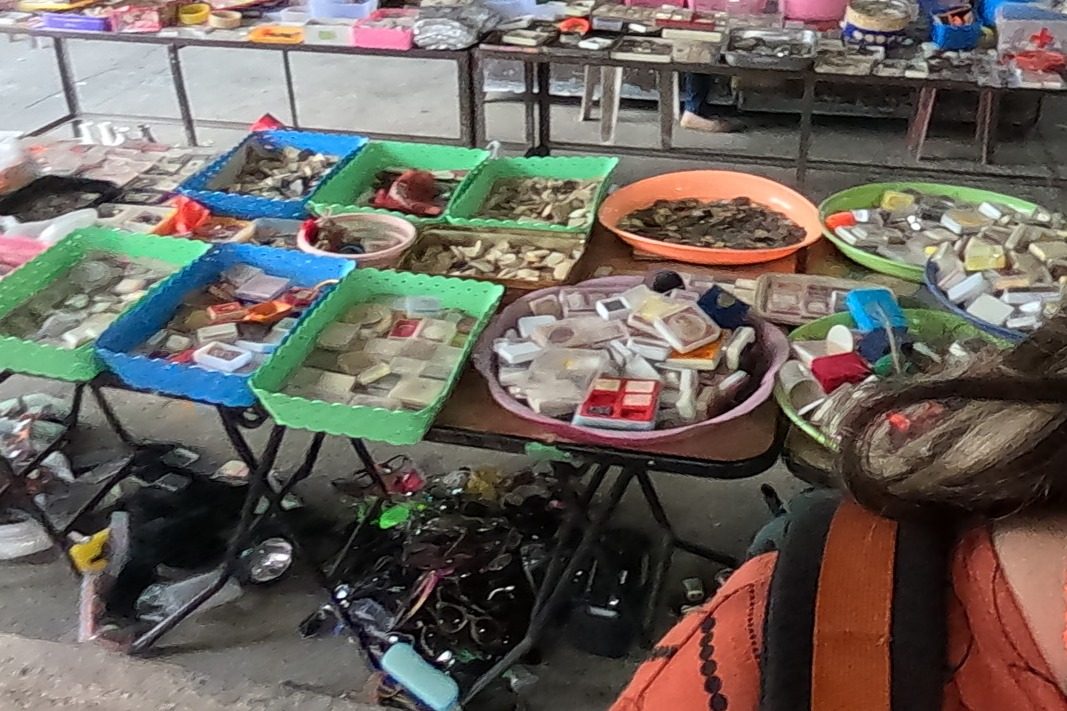 Baskets of cased amulets and coin amulets