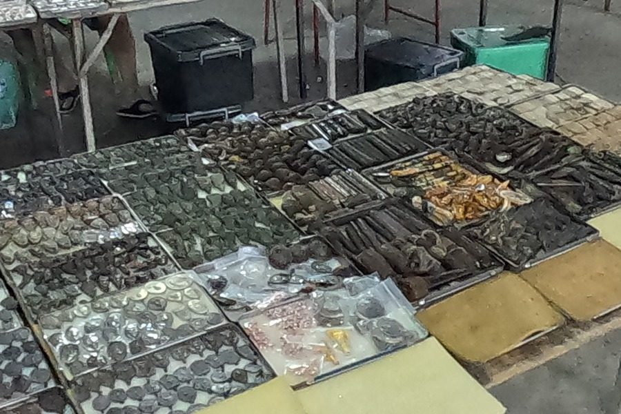 Dark amulets and rolled tube amulets on trays