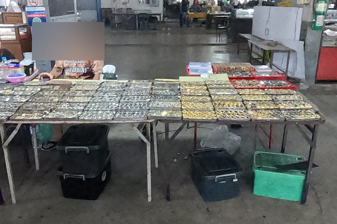 Silver and gold cased amulets on a long table