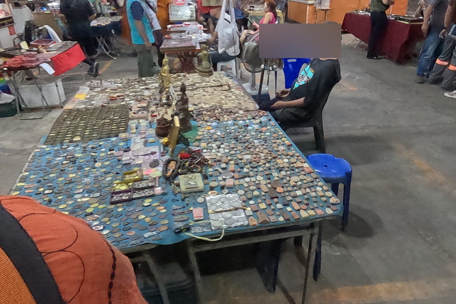 Hundreds of coin amulets on a blue table