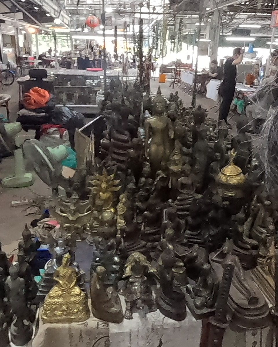 Bronze Buddha images crowded on a stall