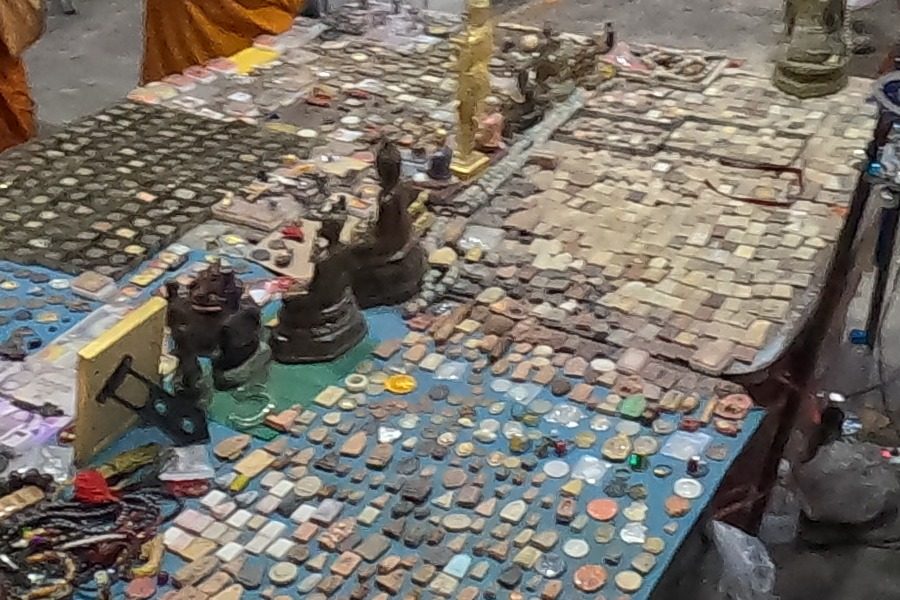 Rows of amulets on blue cloth