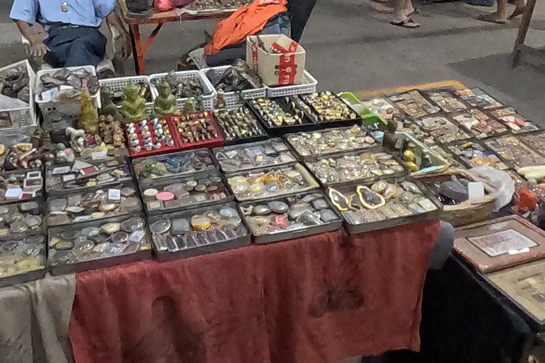 Trays of amulets, rings and small figures