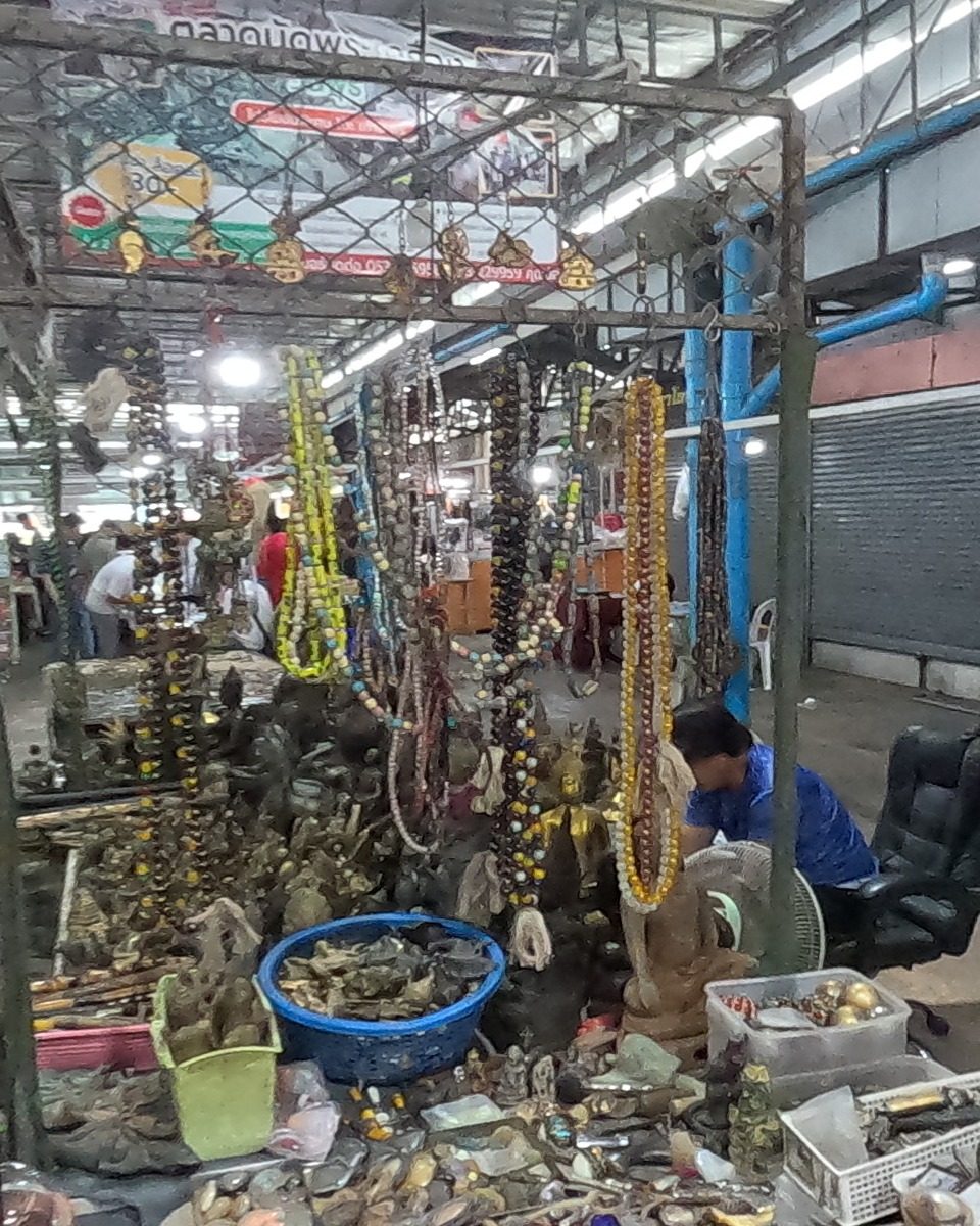 Prayer beads and old brass at a market stall
