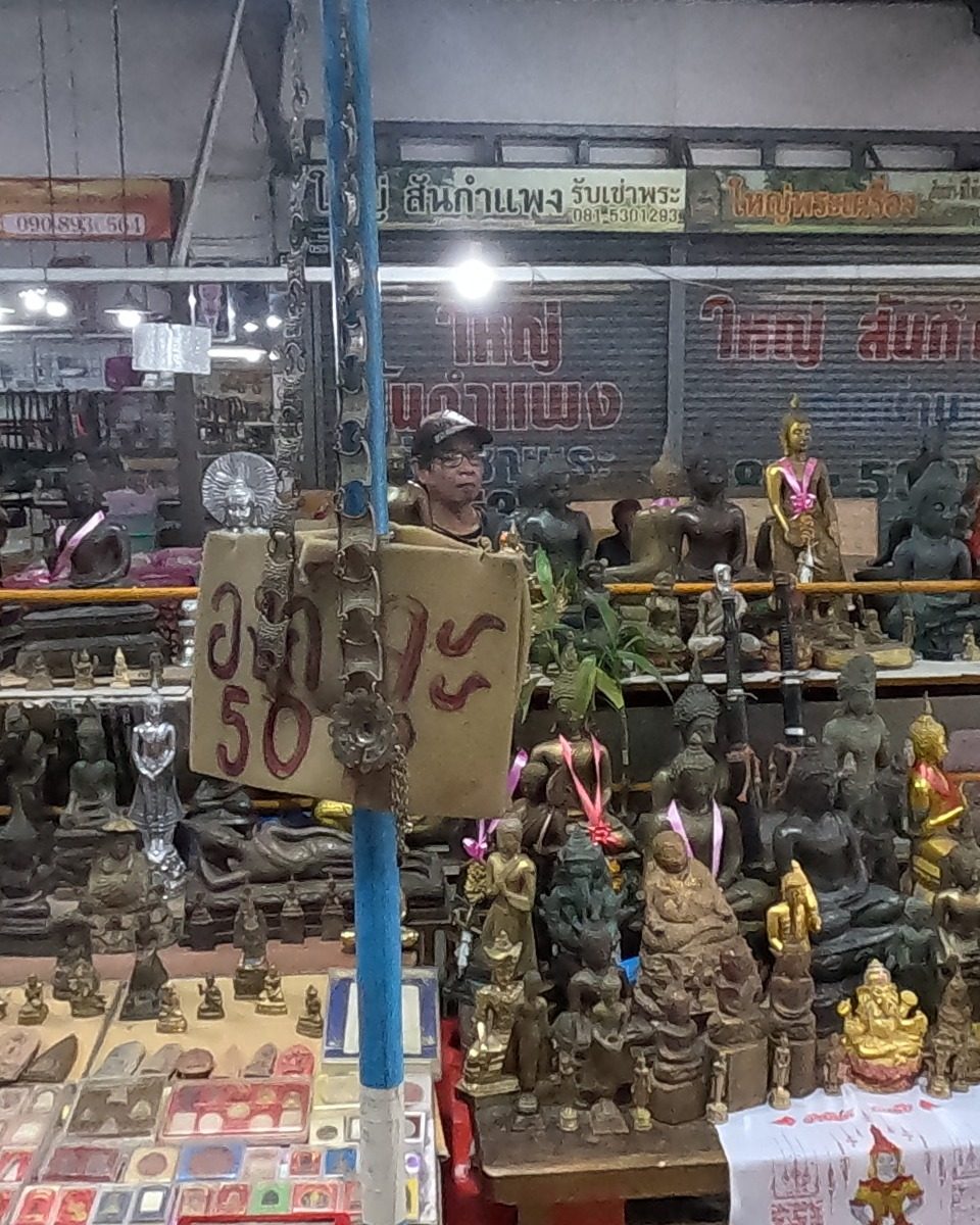 Bronze Buddha images with a hand-written price card