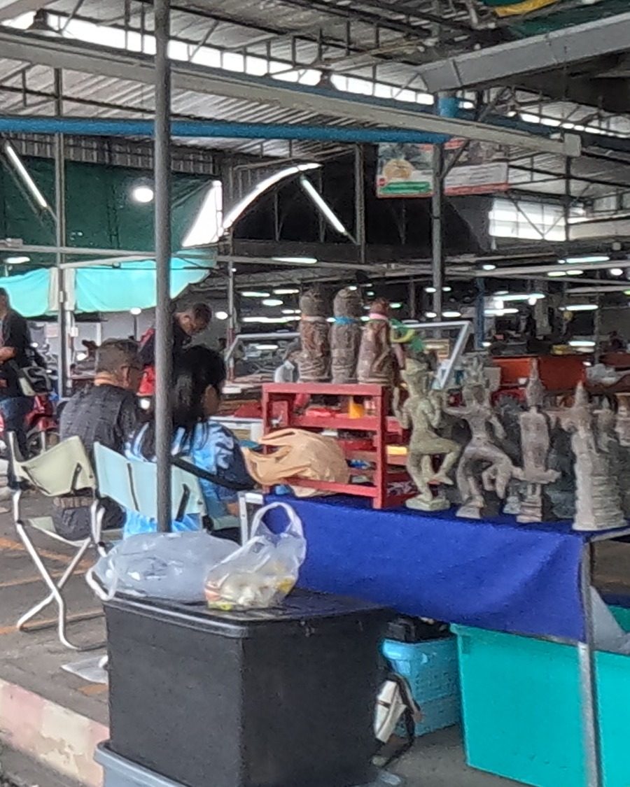 Statues of dancing figures at an outdoor stall