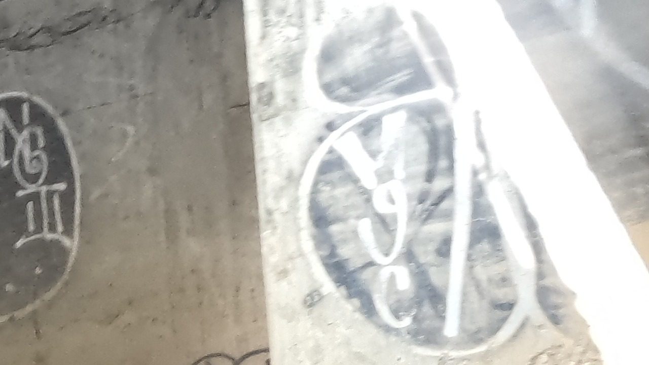 tagged concrete beams inside an underpass