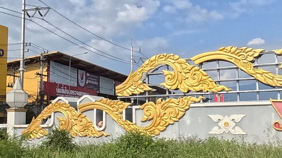 gilded Lanna-style relief ornament on a roundabout wall