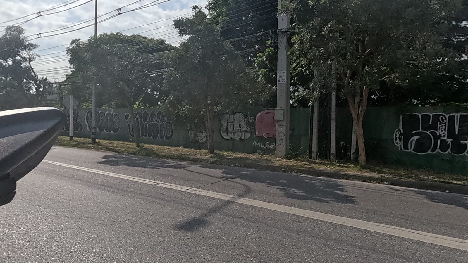 further tagged stretch of the same green boundary wall