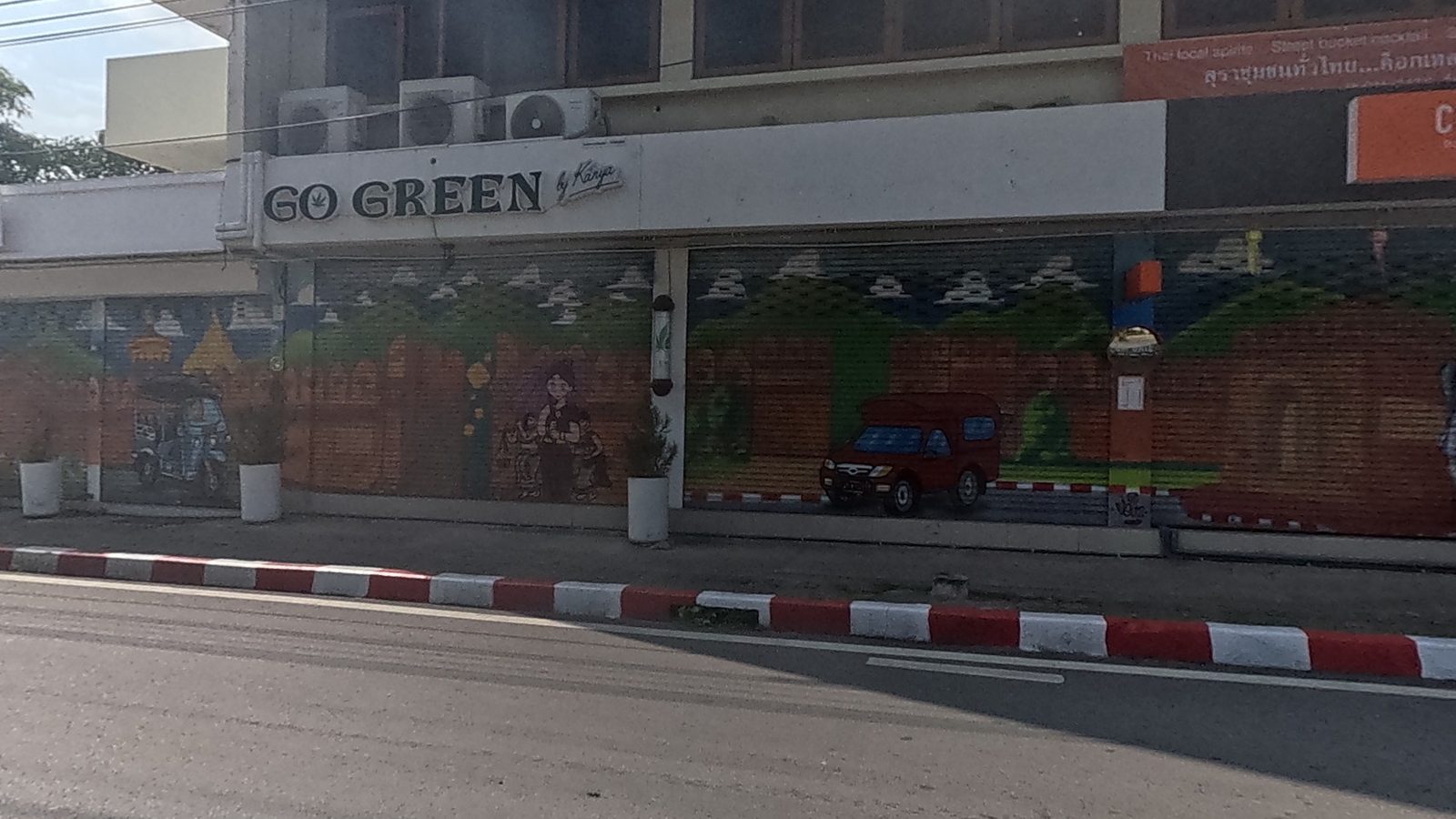 Lanna street-life mural on shop shutters