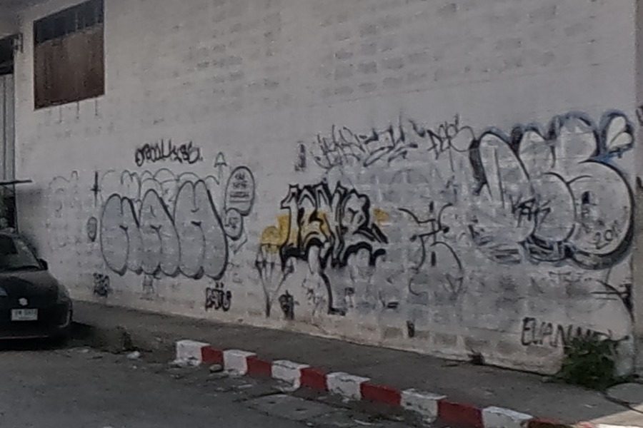 Black-and-yellow tag cluster on a warehouse corner