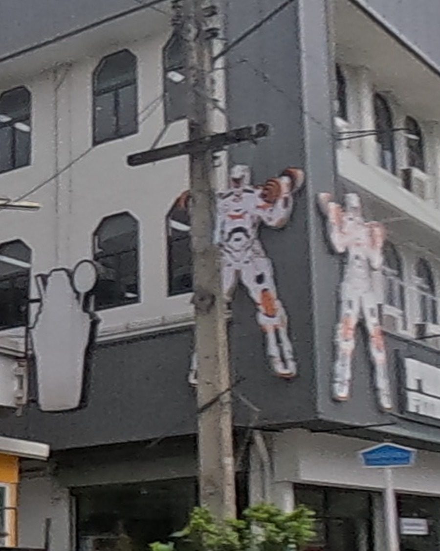 Painted robot/armor figures on building corner