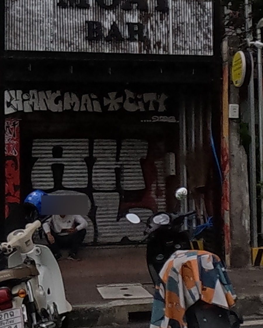 Shutter graffiti: stylized CHIANGMAI CITY tag with bubble tag below
