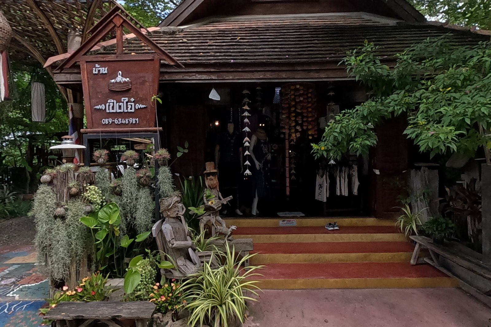 Peng Jai, a wooden house shop with carved figures at the steps — Chamcha Market, San Kamphaeng
