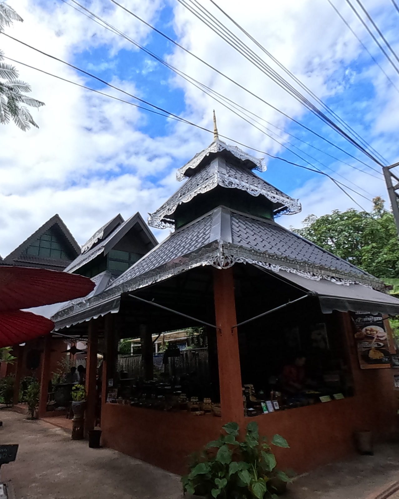 Silver-trimmed Lanna tiered roof — Chamcha Market, San Kamphaeng