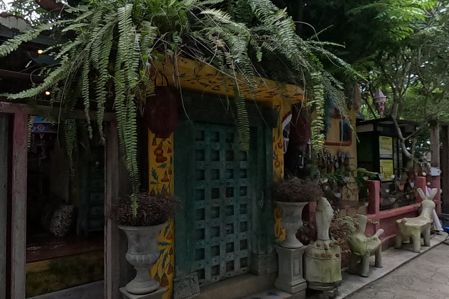 The yellow house with the carved green door — Chamcha Market, San Kamphaeng