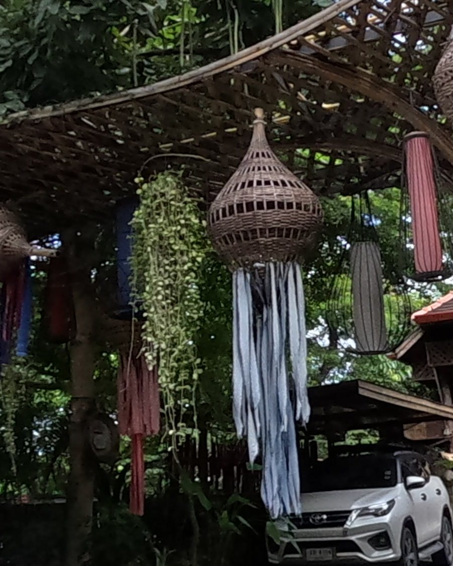 Wicker lantern trailing indigo cloth strips — Chamcha Market, San Kamphaeng