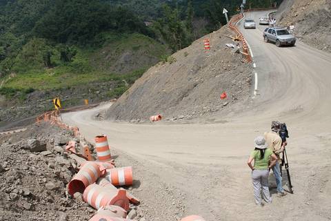 The videographer takes a video of the dangerous hairpin bend on a mountain road in Xiaolin Village.