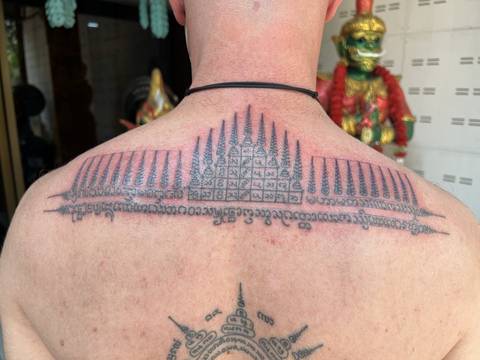 A finished spires yant across the upper back, at Sak Yant Chiang Mai.