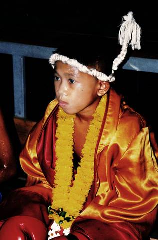 Young Thai boxer waiting for his call to the ring.