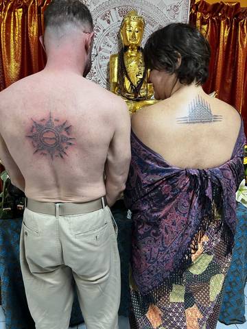 Two finished backs in front of the shrine, at Sak Yant Chiang Mai.