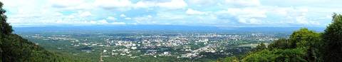 Panorama of Chiang Mai during the rainy season when the skies are more clear and the surroundings more luscious green. The image was taken from the viewpoint halfway up Doi Suthep. The mountains on th