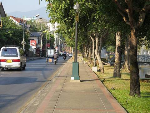 The moat of Chiang Mai during the day. A road is on the left, and the moat is on the right. This picture was taken on the north side of the city center. Thailand.