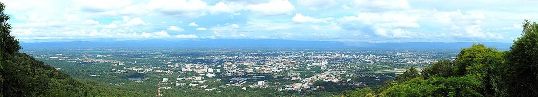 Panorama of Chiang Mai during the rainy season when the skies are more clear and the surroundings more luscious green. The image was taken from the viewpoint halfway up Doi Suthep. The mountains on th