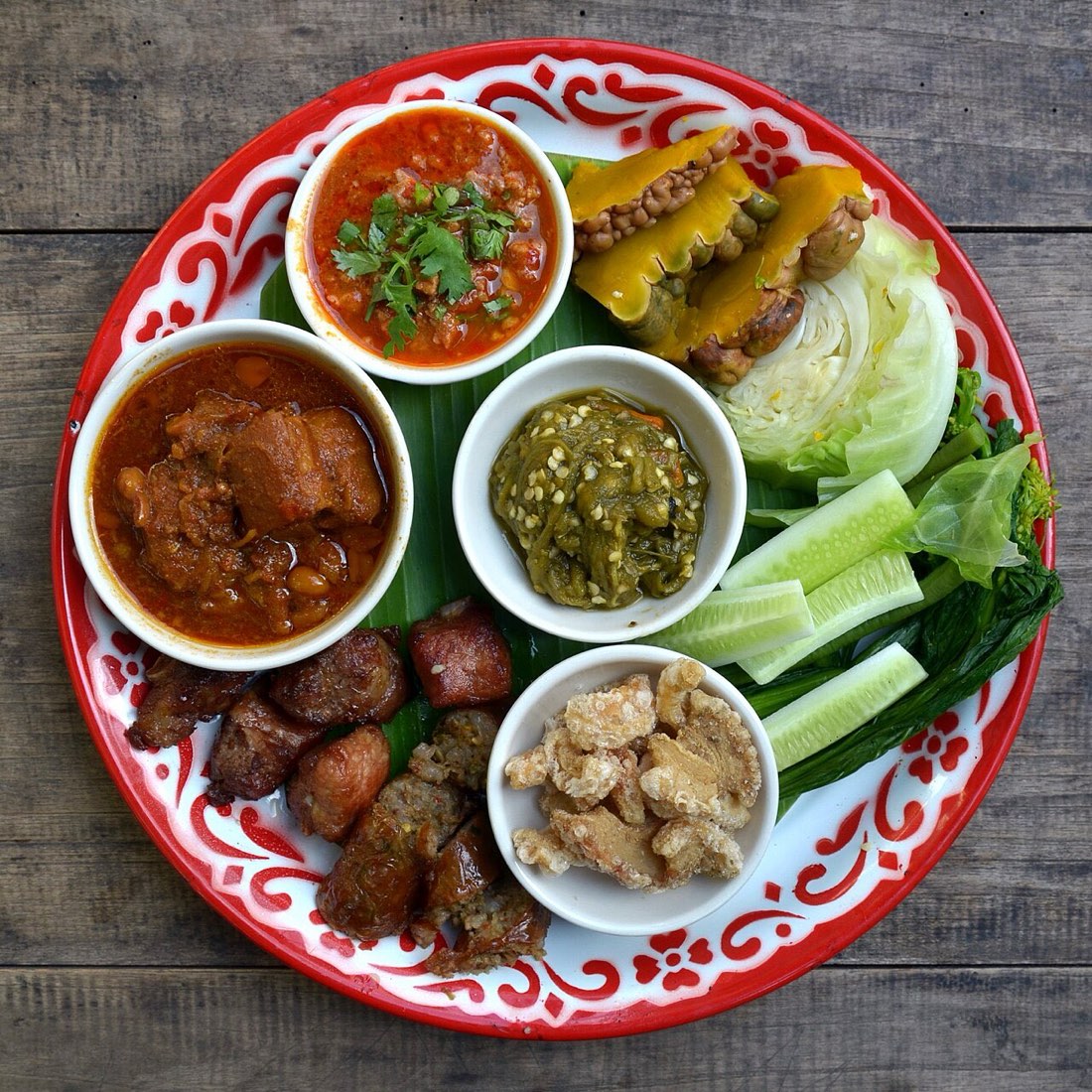 A sampling of Northern Thai (Lanna) cuisine, here served as starters at "Huen Muan Jai" northern Thai restaurant in Chiang Mai. Starting from the top: nam phrik