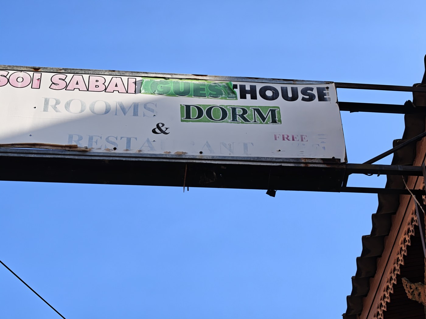 Soi Sabai Guesthouse's arch sign: rooms, dorm & restaurant