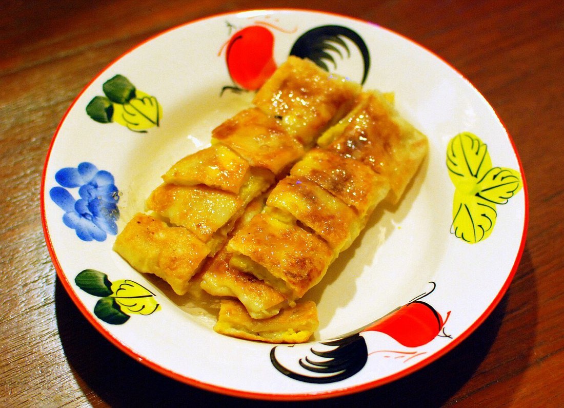 Roti kluai khai is Thai for a roti with banana and egg. Banana slices and a beaten egg are fried inside a roti, then cut and served with condensed sweetened mil