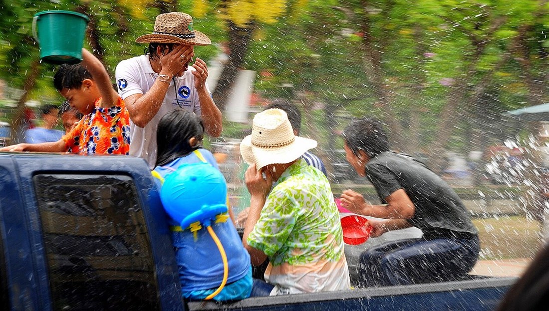 People on the back of a truck get soaked during the Songkran festival in Chiang Mai, Thailand