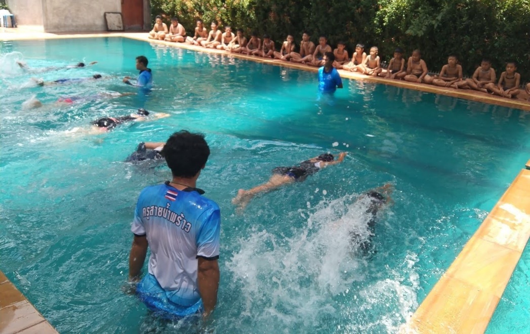 Coach Kru Payu and certified swim instructors