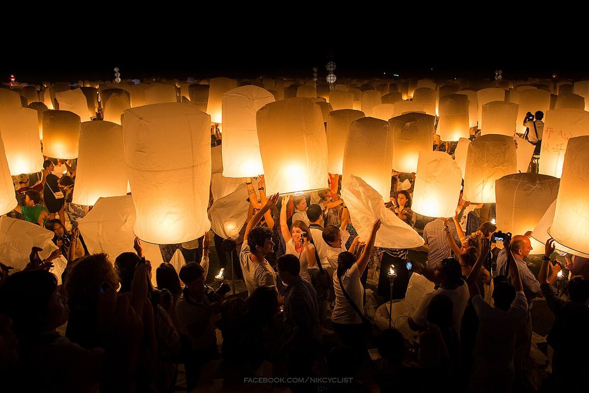 Holding lit lanterns while they fill, Yi Peng in Chiang Mai, 2013.