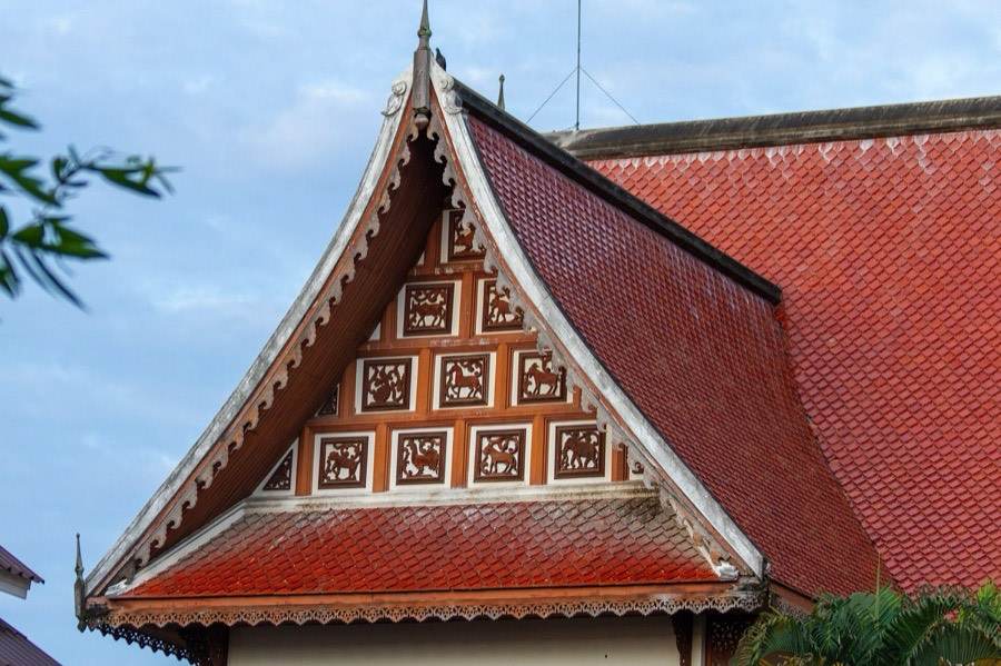 A wooden gable carved in square openwork panels.