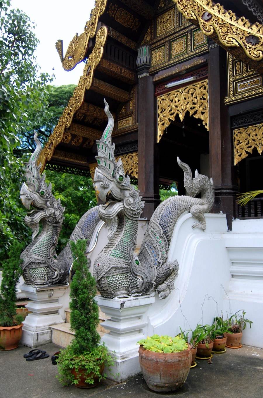 Nagas pour from the mouths of makaras along a stair rail.