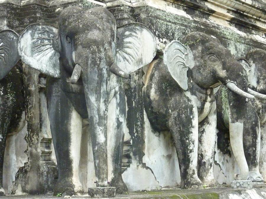 A ring of stucco elephants holds up the chedi.