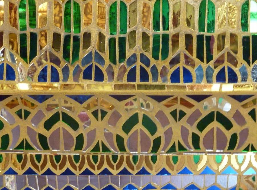 Coloured glass and gold set in bands of lotus petals.