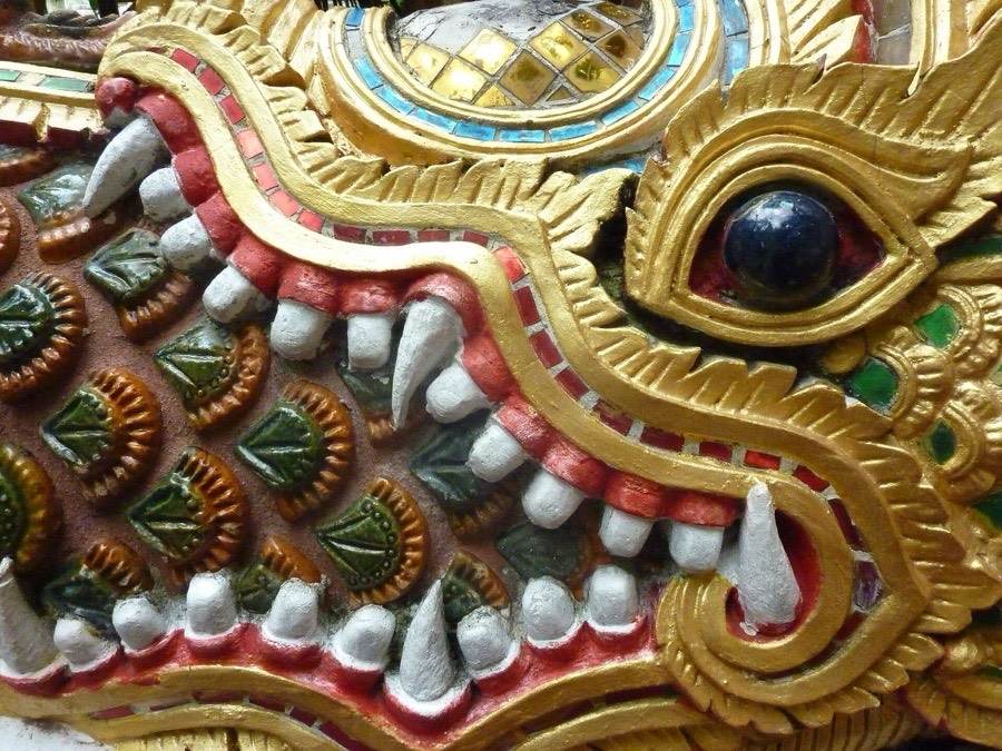 A makara spits out a naga, every scale picked out in gilt.