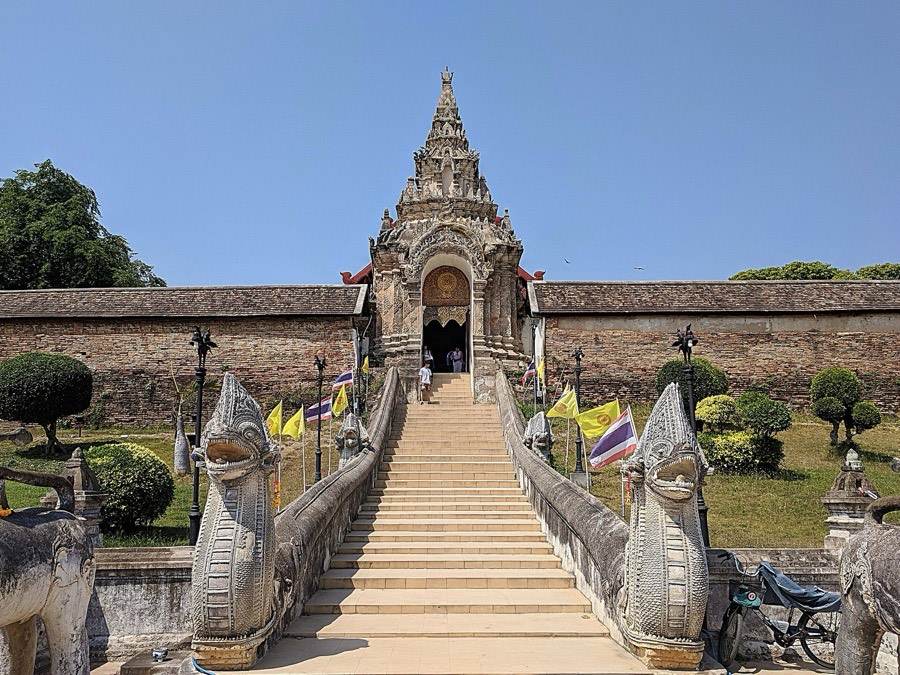 A stair between two nagas leads up to the temple gate.