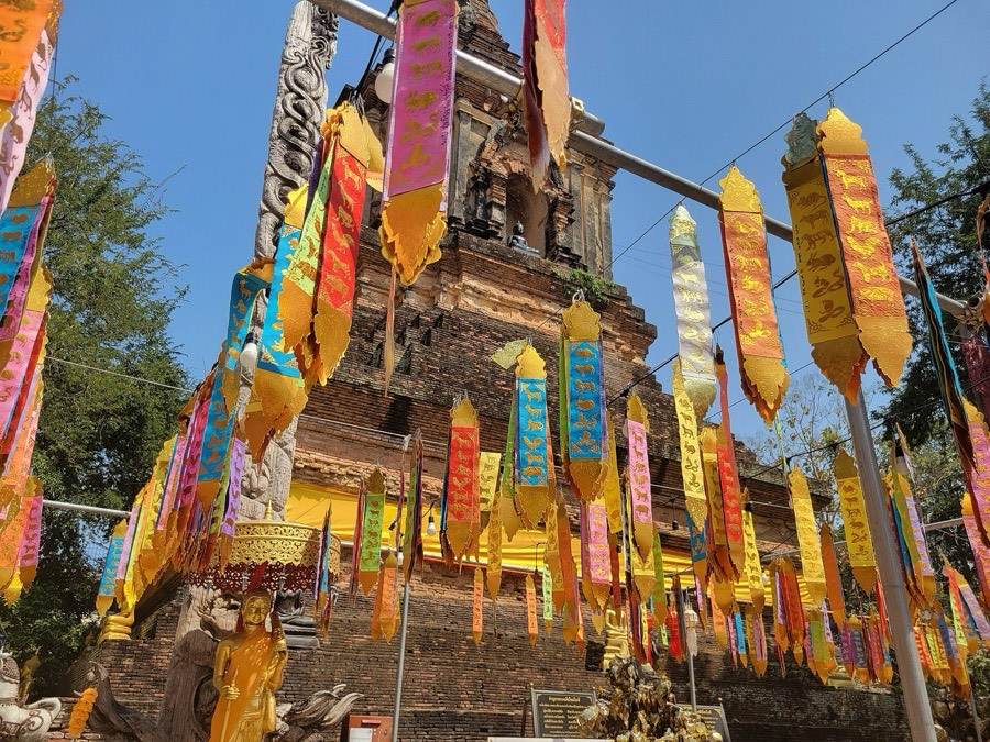 Bright tung banners hang over the brick chedi of Lok Molee.