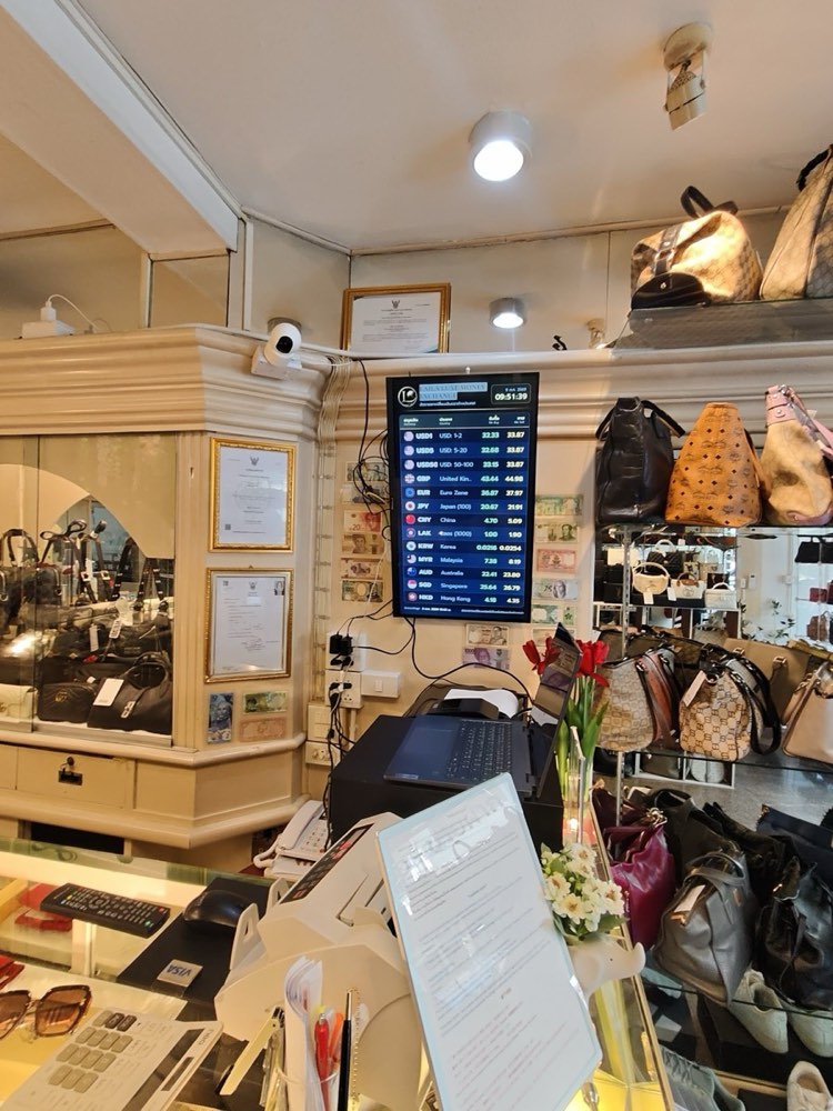 Laila's exchange counter with the rate screen and handbags behind