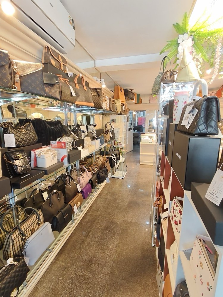 An aisle of pre-owned designer handbags at Laila Luxe