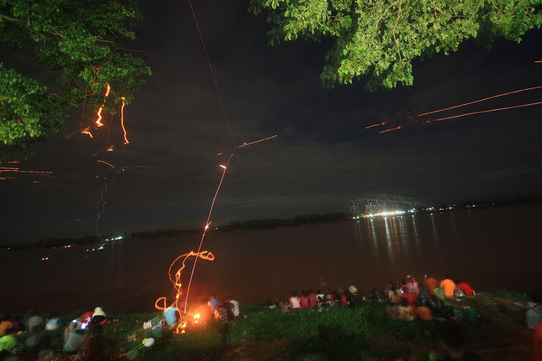 Fireball trails over the Mekong and the crowd on the Thai bank, 2013
