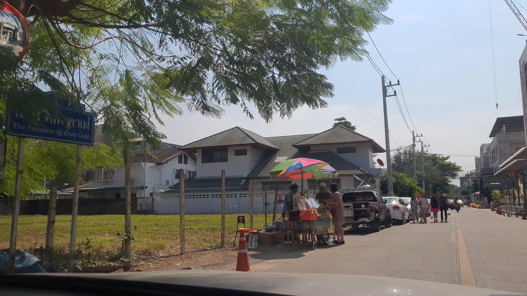 ภาพถนนตรงที่ ลานจอดรถ · นอกเวียง ทางตะวันตกเฉียงเหนือ ห่างคูเมือง 1.2 กม. ตั้งอยู่ ถ่ายโดย jrcarlsen พ.ศ. 2566 (2023) · A street-level view of where Car park · Outside the moat to the north-west, 1.2 km from the water stands, by jrcarlsen in 2566 (2023)
