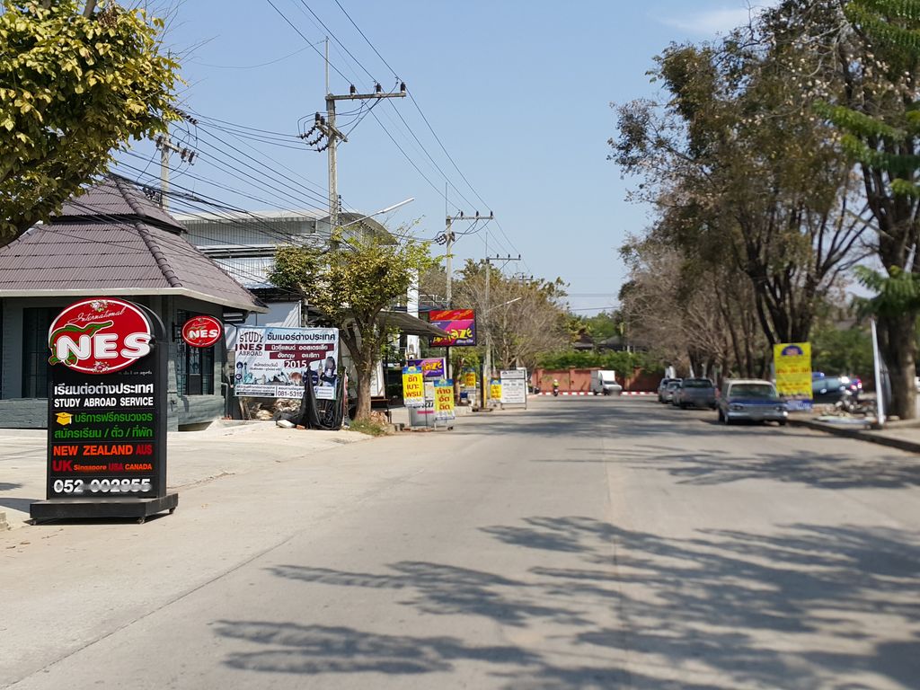 ภาพถนนตรงที่ ที่จอดรถ · ห่างกลางมหาวิทยาลัยพายัพ 1.0 กม. ไปทางตะวันตกเฉียงเหนือ ตั้งอยู่ ถ่ายโดย jrcarlsen พ.ศ. 2558 (2015) · A street-level view of where Parking · 1.0 km north-west of the middle of Payap University stands, by jrcarlsen in 2558 (2015)