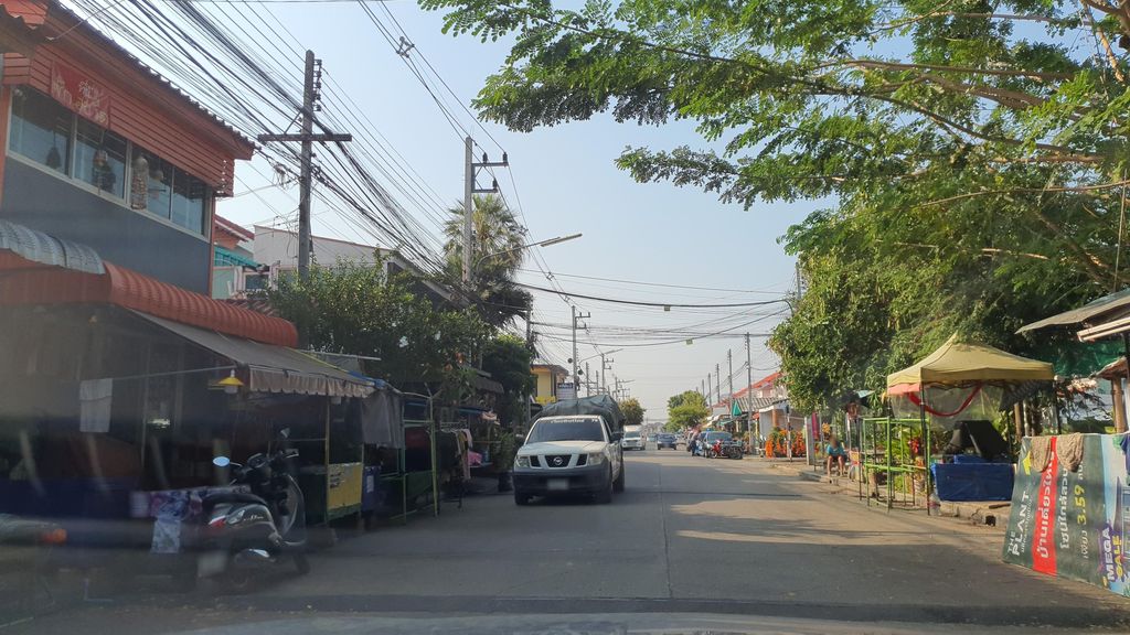 ภาพถนนตรงที่ หมู่บ้านเอื้ออาทรสันกำแพง ตั้งอยู่ ถ่ายโดย jrcarlsen พ.ศ. 2565 (2022) · A street-level view of where หมู่บ้านเอื้ออาทรสันกำแพง · Ueaat San Kamphaeng Village stands, by jrcarlsen in 2565 (2022)